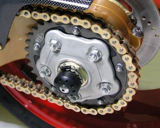 Rear wheel axle slider with titanium screws